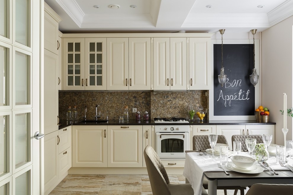 Inspiration for a transitional l-shaped separate kitchen in Saint Petersburg with raised-panel cabinets, white cabinets, brown splashback, white appliances, no island, beige floor and black benchtop.