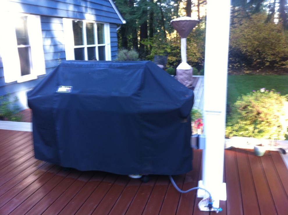 Inspiration for a transitional backyard deck remodel in Seattle with a pergola
