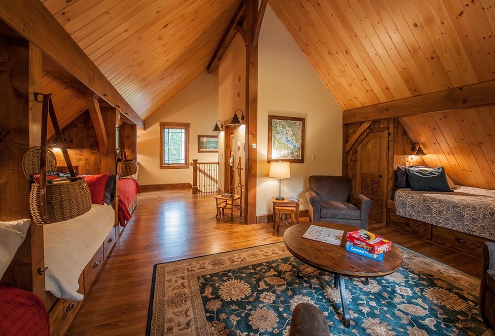 Large country guest bedroom in Burlington with beige walls and medium hardwood floors.