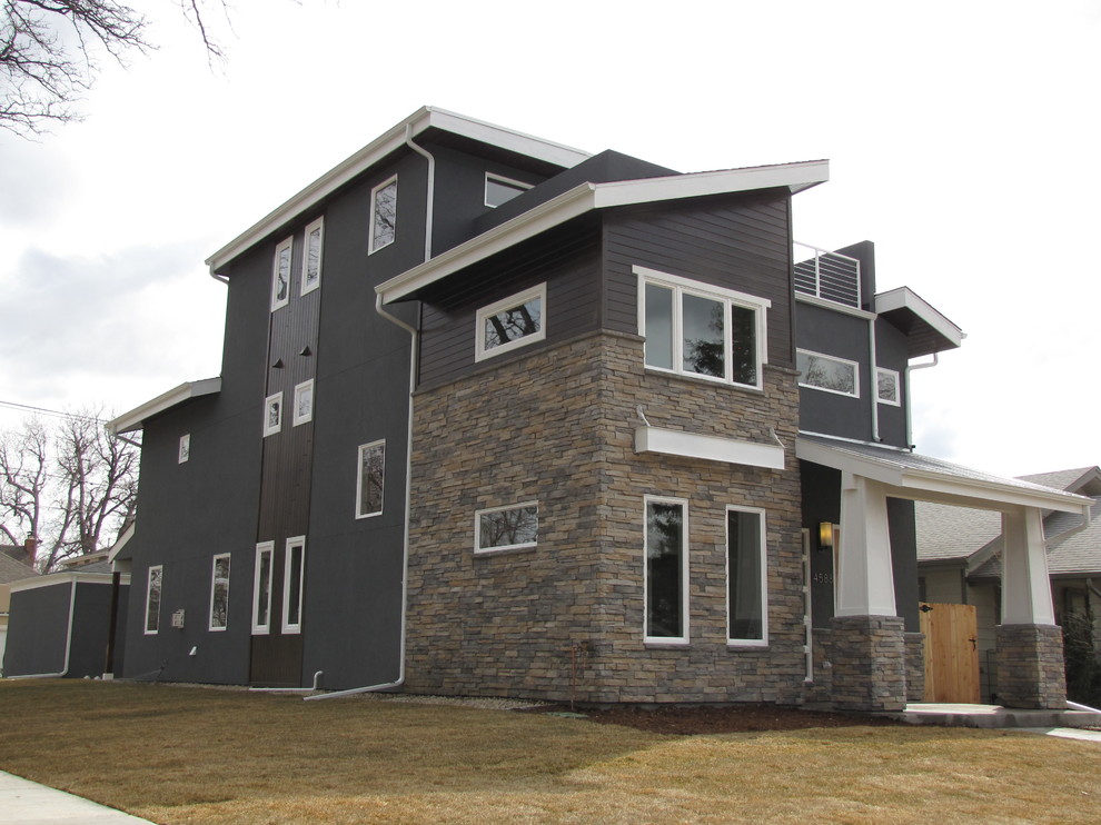 Design ideas for a large transitional three-storey grey exterior in Denver with stone veneer.