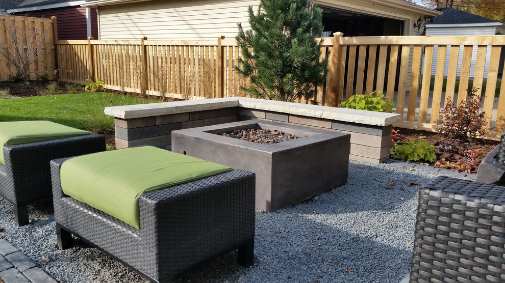 Inspiration for a modern backyard gravel patio remodel in Chicago with a fire pit