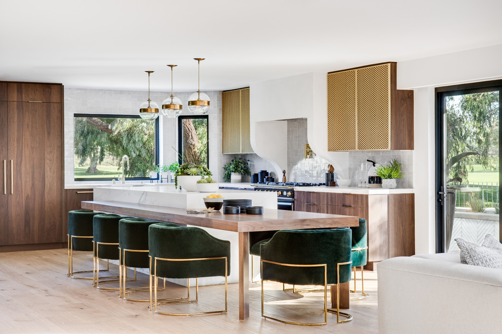 This is an example of a contemporary l-shaped open plan kitchen in Orange County with flat-panel cabinets, brown cabinets, grey splashback, light hardwood floors, with island, beige floor and white benchtop.