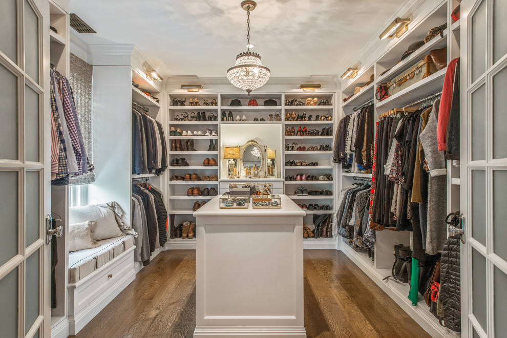 Inspiration for a traditional gender-neutral walk-in wardrobe in Santa Barbara with open cabinets, white cabinets, dark hardwood floors and brown floor.