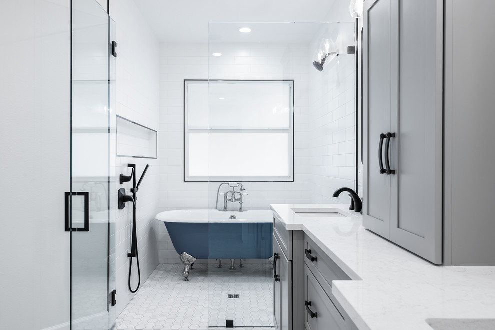 This is an example of a large transitional master bathroom in Tampa with shaker cabinets, grey cabinets, a claw-foot tub, a curbless shower, a two-piece toilet, white tile, porcelain tile, grey walls, porcelain floors, an undermount sink, engineered quartz benchtops, white floor, a hinged shower door and white benchtops.
