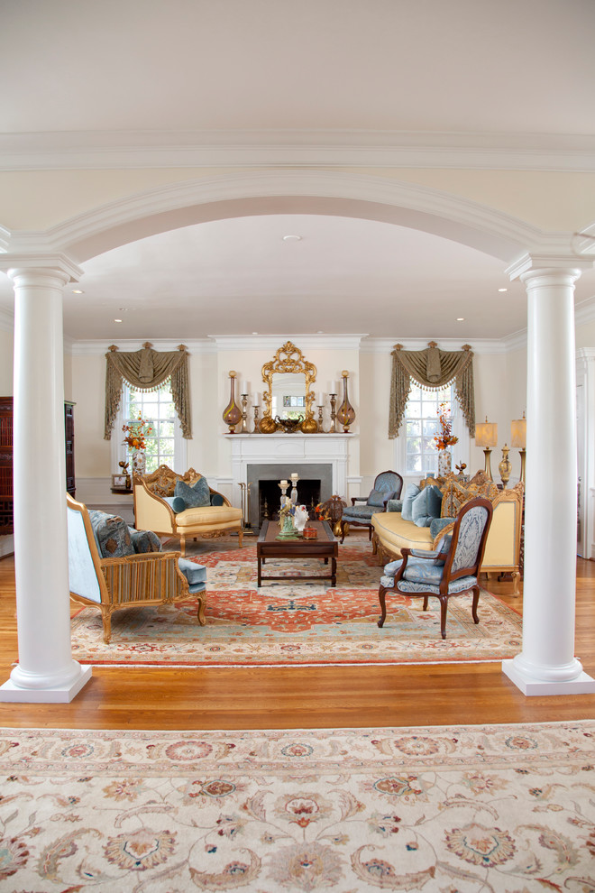 Large traditional formal open concept living room in Other with white walls, light hardwood floors, a standard fireplace, a plaster fireplace surround and no tv.