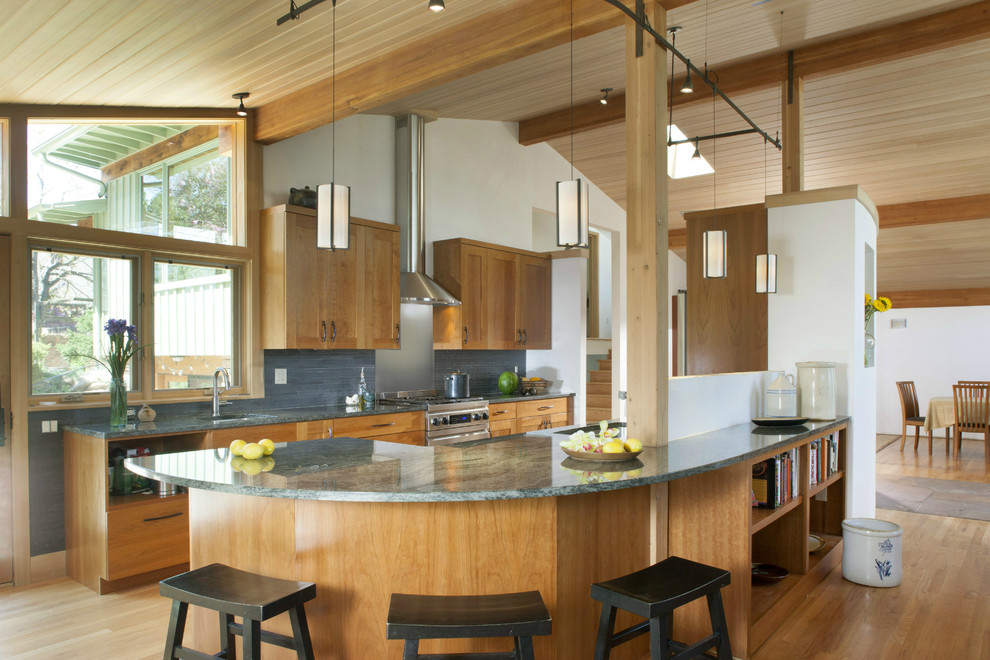 Inspiration for a mid-sized midcentury galley open plan kitchen in Denver with a single-bowl sink, shaker cabinets, medium wood cabinets, granite benchtops, grey splashback, mosaic tile splashback, stainless steel appliances, medium hardwood floors and with island.
