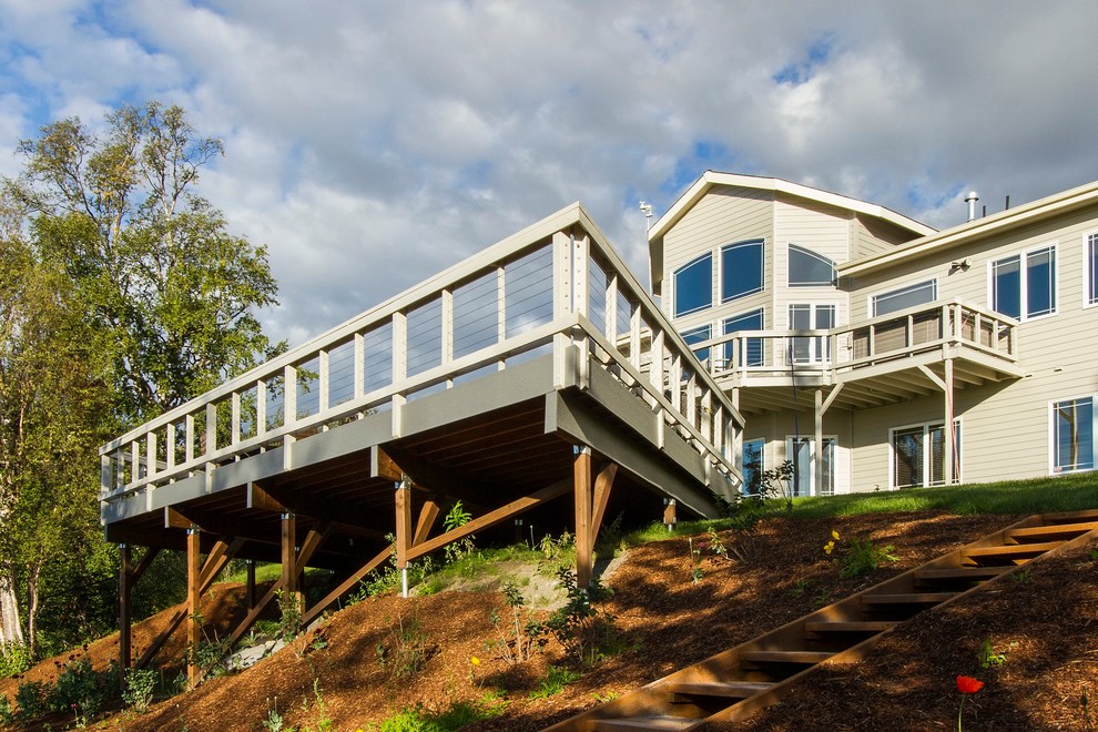 This is an example of a large modern backyard deck in Other.