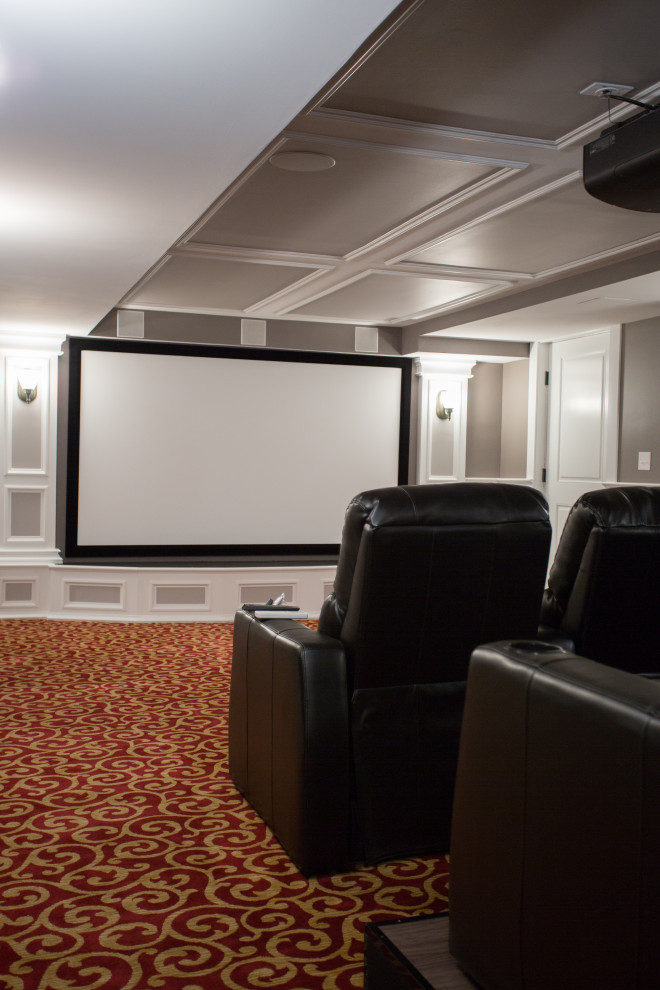 Photo of a traditional home theatre with beige walls, carpet, a projector screen and red floor.