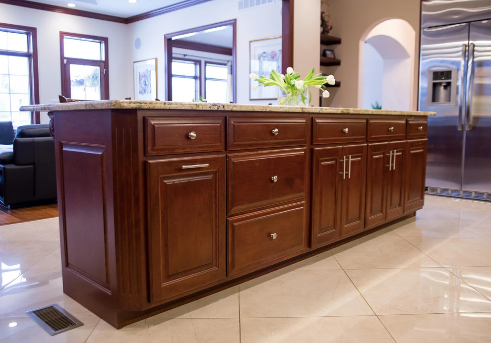 Open concept kitchen - large modern u-shaped porcelain tile and beige floor open concept kitchen idea with an undermount sink, raised-panel cabinets, dark wood cabinets, granite countertops, beige backsplash, matchstick tile backsplash, stainless steel appliances, an island and multicolored countertops