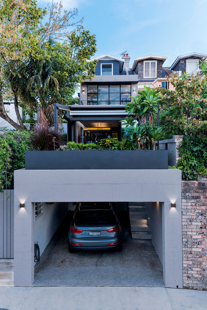 This is an example of a mid-sized contemporary attached one-car garage in Sydney.