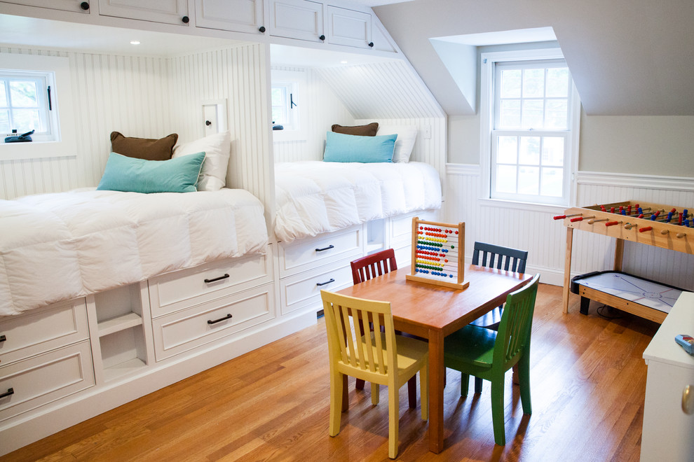 Beach style gender-neutral kids' bedroom in New York with grey walls and medium hardwood floors for kids 4-10 years old.