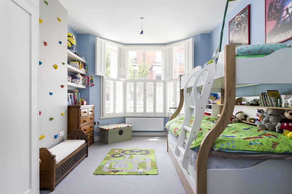 Mid-sized eclectic kids' bedroom in London with blue walls, carpet and grey floor for kids 4-10 years old and boys.