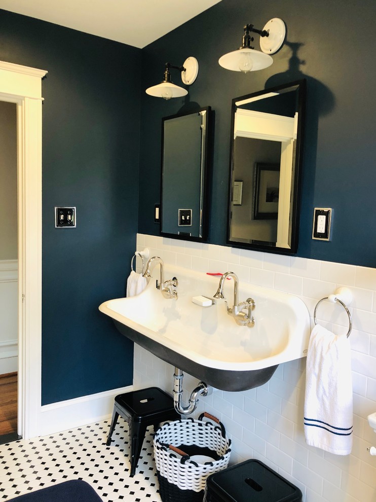 Inspiration for a small kids bathroom in Philadelphia with an alcove shower, white tile, blue walls, ceramic floors, a trough sink and a hinged shower door.
