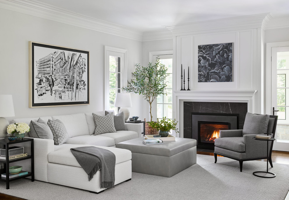 Photo of a transitional family room in Chicago with white walls, medium hardwood floors, a standard fireplace, a stone fireplace surround and brown floor.