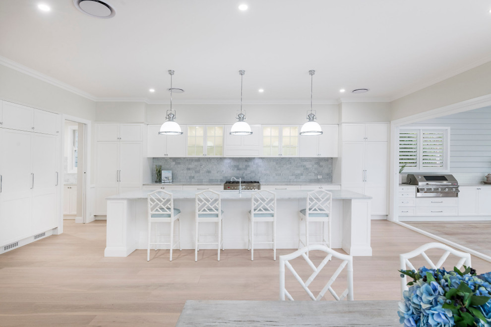 Large beach style galley eat-in kitchen in Brisbane with with island.