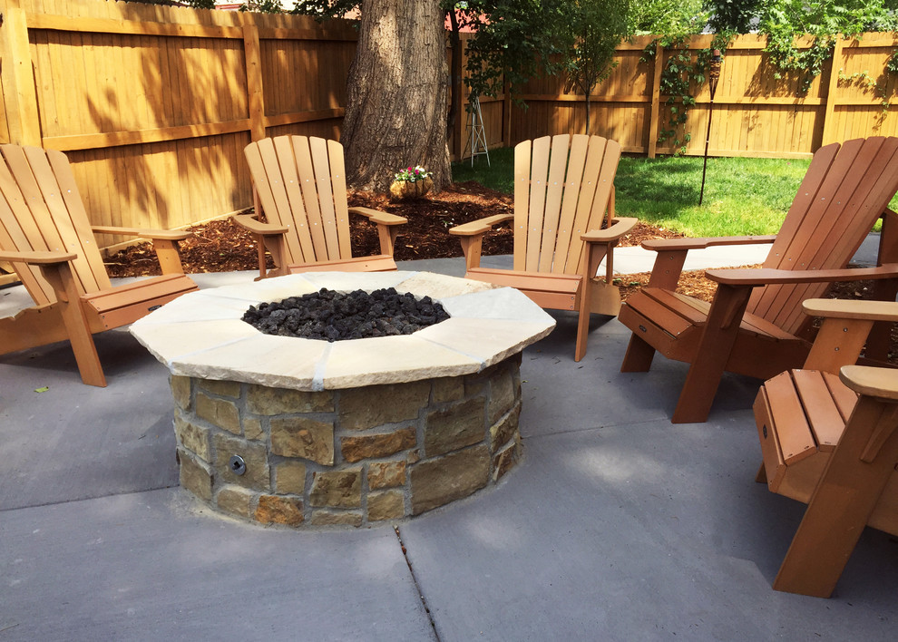 Photo of a mid-sized traditional backyard patio in Denver with a fire feature, concrete pavers and no cover.