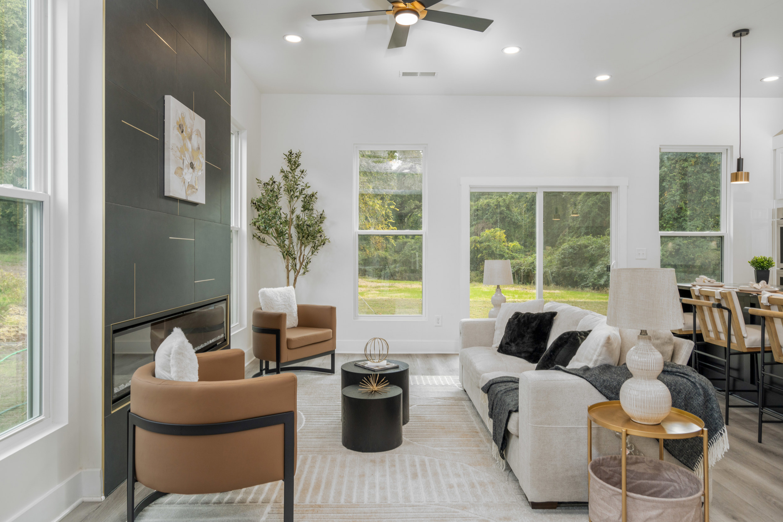 Example of a trendy open concept living room design in Atlanta with white walls and a ribbon fireplace