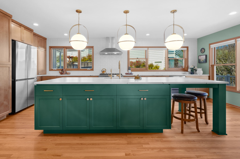 Transitional l-shaped medium tone wood floor kitchen photo with shaker cabinets, white backsplash, an island and white countertops