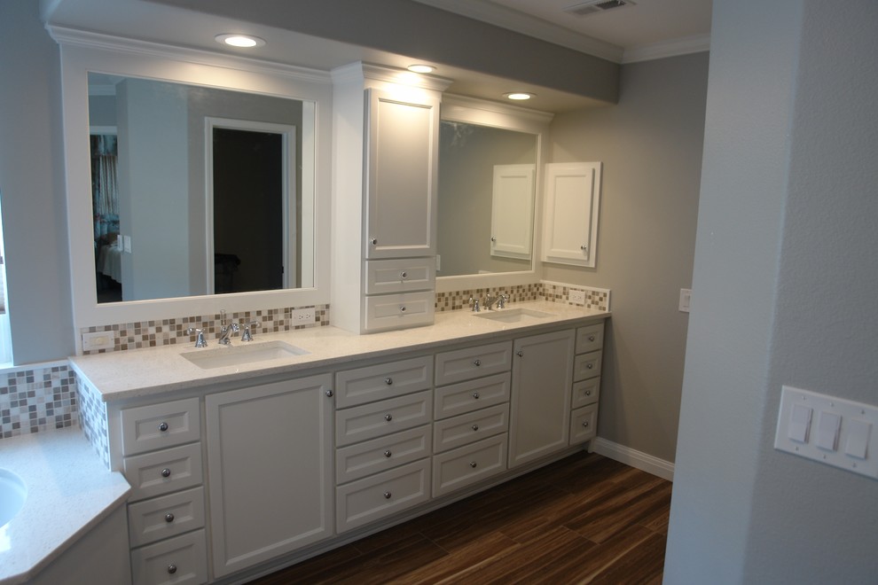 Large modern master bathroom in Denver with an undermount sink, recessed-panel cabinets, white cabinets, granite benchtops, an undermount tub, brown tile, porcelain tile, grey walls and porcelain floors.