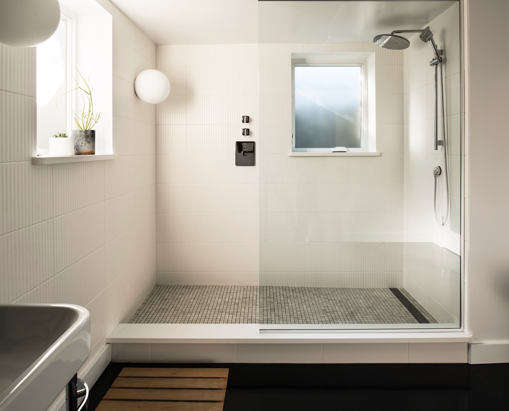 Photo of a large contemporary master bathroom in Portland with an open shower, white tile, white walls, concrete floors, a console sink, engineered quartz benchtops, black floor, an open shower and white benchtops.