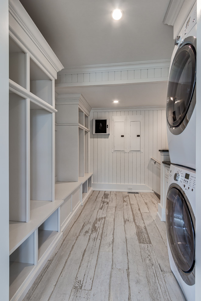 Photo of a large beach style mudroom in Philadelphia with white walls and ceramic floors.