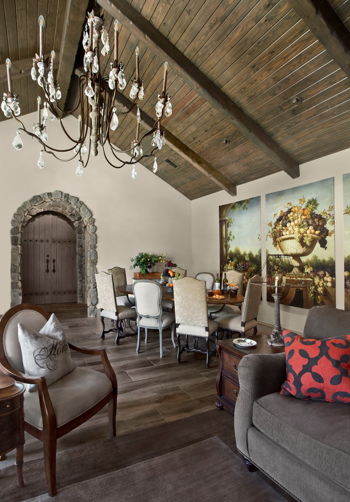 This is an example of a mediterranean dining room in Houston with white walls and dark hardwood floors.