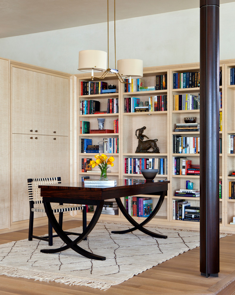 This is an example of a contemporary home office in Austin with white walls.