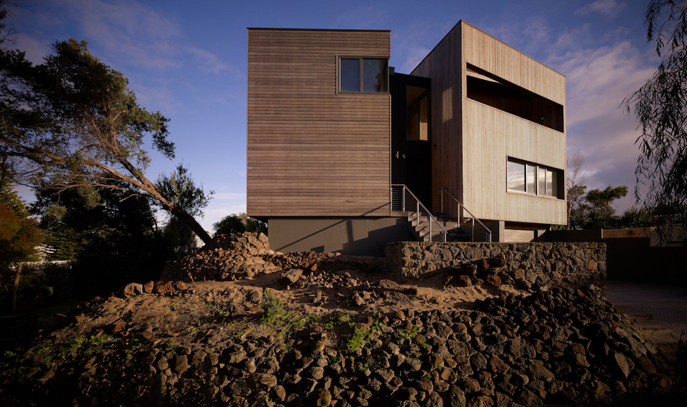 This is an example of a large contemporary two-storey brown exterior in Geelong with wood siding and a flat roof.
