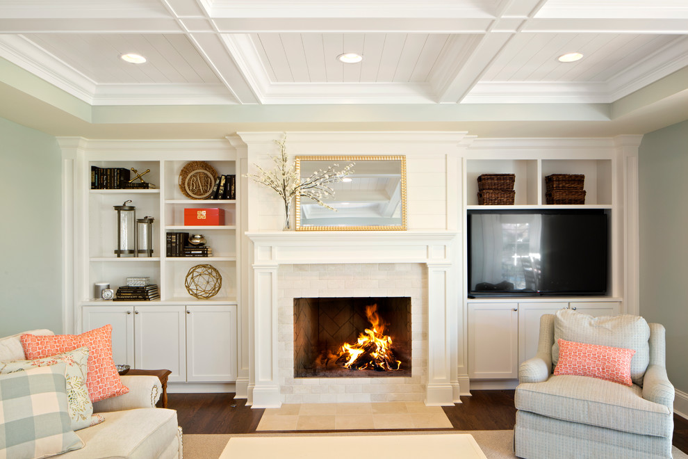 Inspiration for a large traditional enclosed family room in Cincinnati with dark hardwood floors, a standard fireplace, a tile fireplace surround, a built-in media wall, blue walls and brown floor.