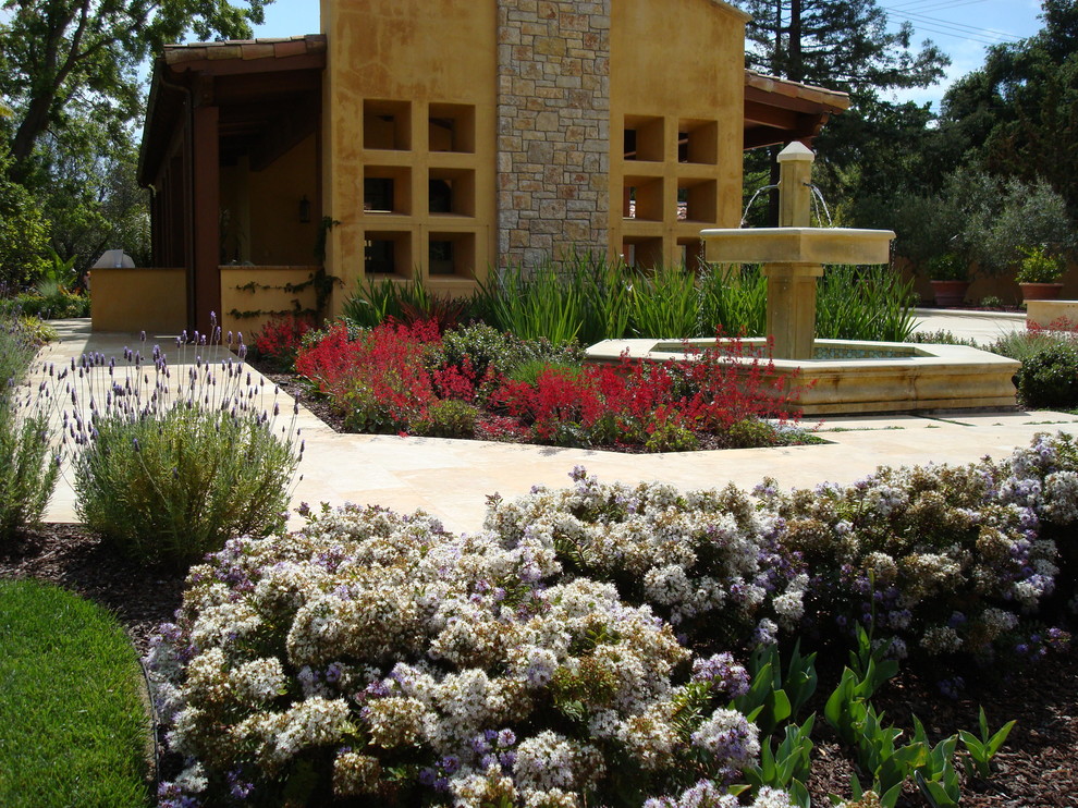 Design ideas for a large mediterranean courtyard full sun formal garden in San Francisco with a water feature and concrete pavers.