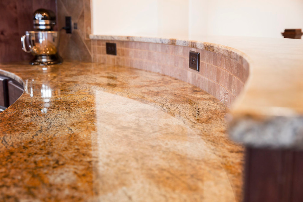 Example of a large transitional u-shaped dark wood floor home design design in Denver with an undermount sink, shaker cabinets, dark wood cabinets, granite countertops, beige backsplash, ceramic backsplash, stainless steel appliances and an island