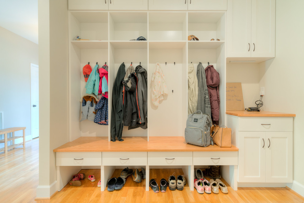 Inspiration for a mid-sized transitional light wood floor mudroom remodel