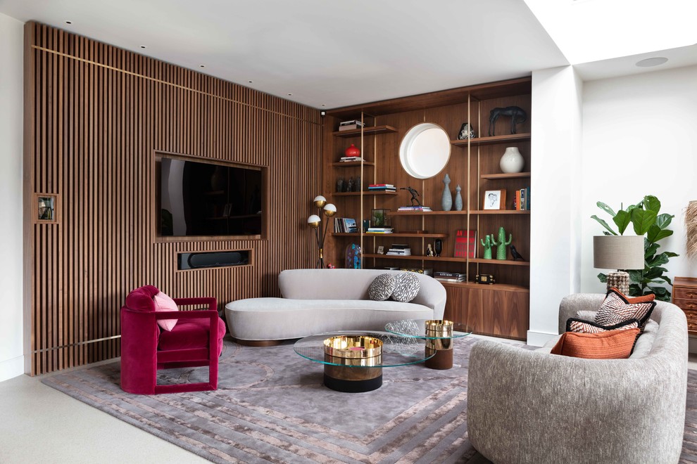 Expansive contemporary open concept living room in London with white walls, concrete floors, grey floor and a wall-mounted tv.