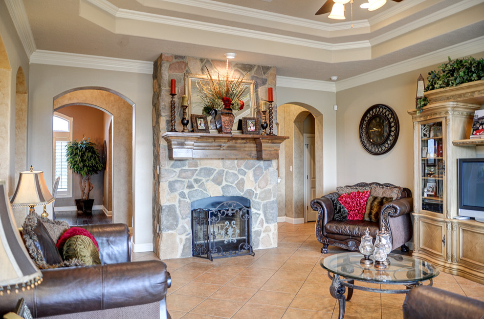 Large country open concept family room in Austin with beige walls, porcelain floors, a standard fireplace and a stone fireplace surround.