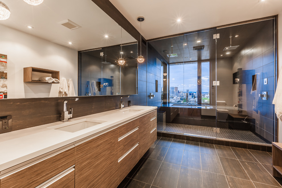 Inspiration for a contemporary bathroom in Seattle with an undermount sink, flat-panel cabinets, medium wood cabinets, an undermount tub, an alcove shower and gray tile.