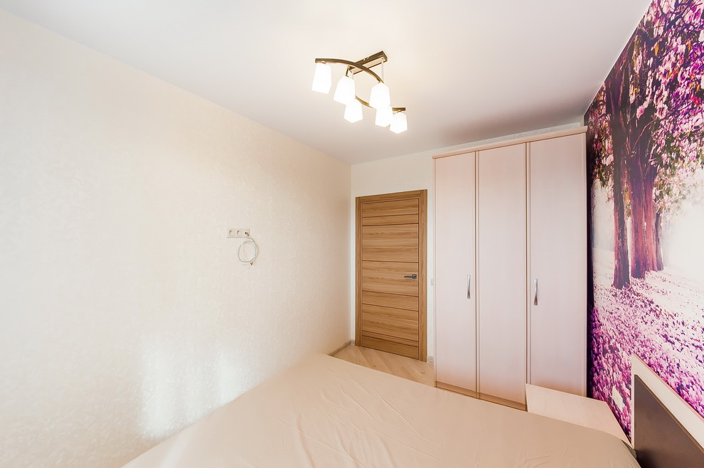 Photo of a small contemporary master bedroom in Moscow with beige walls, laminate floors and beige floor.