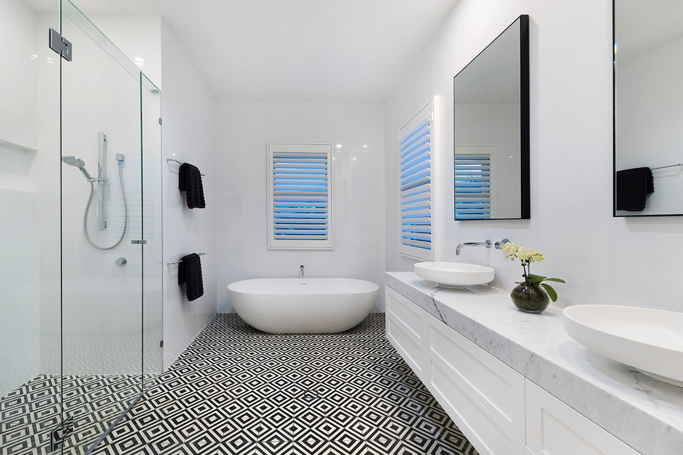 Inspiration for a large traditional master bathroom in Brisbane with shaker cabinets, white cabinets, an alcove shower, a one-piece toilet, white tile, porcelain tile, white walls, porcelain floors, a console sink, marble benchtops, multi-coloured floor, a hinged shower door and grey benchtops.
