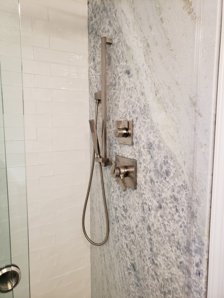This is an example of a small contemporary bathroom in Charlotte with a corner shower, multi-coloured tile, stone tile, white walls, mosaic tile floors, green floor and a sliding shower screen.