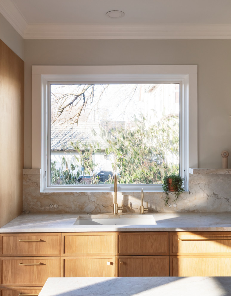 Eat-in kitchen photo in Newark with an undermount sink, medium tone wood cabinets, quartzite countertops, stone slab backsplash, an island and paneled appliances