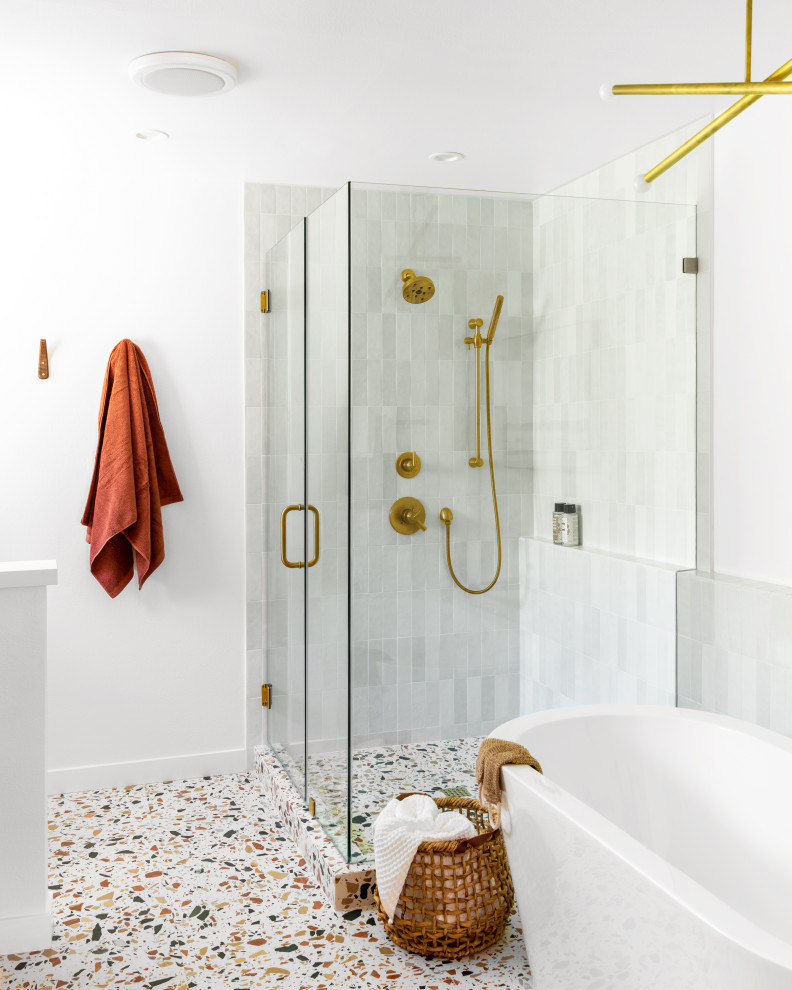 Photo of a contemporary master bathroom in Orange County with a freestanding tub, an alcove shower, gray tile, white tile, white walls, terrazzo floors, multi-coloured floor, a hinged shower door and white benchtops.