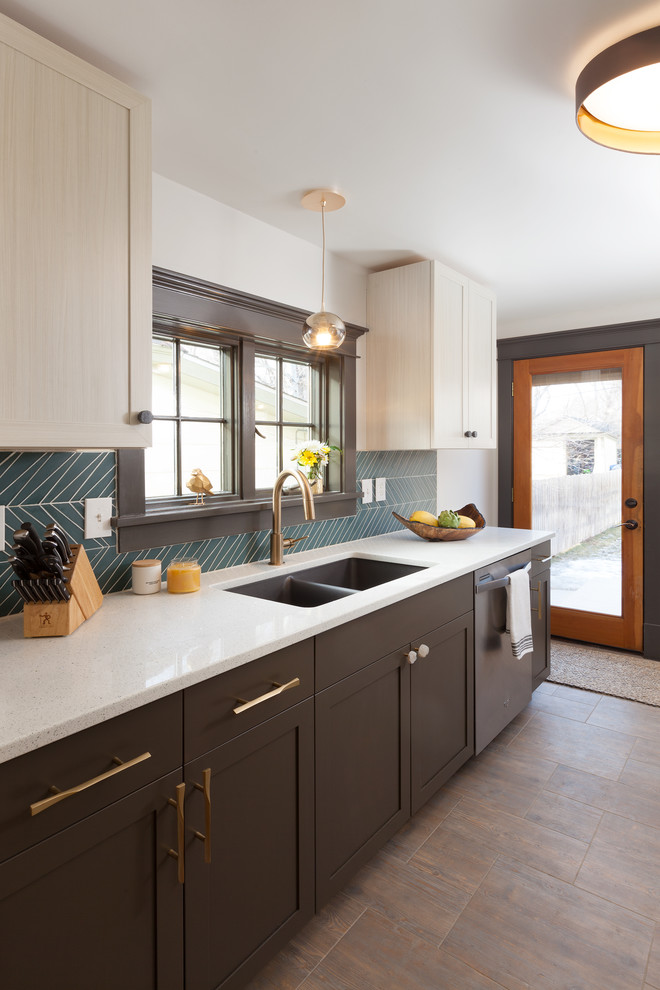 Photo of a contemporary kitchen in Denver with a double-bowl sink, shaker cabinets, brown cabinets, blue splashback, stainless steel appliances, no island, brown floor and white benchtop.