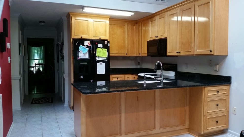 Example of a mid-sized transitional l-shaped ceramic tile open concept kitchen design in Richmond with an undermount sink, recessed-panel cabinets, light wood cabinets, quartzite countertops, black backsplash, stone slab backsplash, black appliances and an island