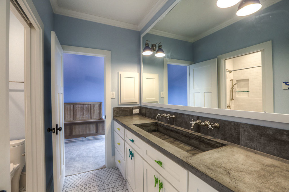 Design ideas for a large country kids bathroom in Houston with shaker cabinets, white cabinets, an alcove tub, a shower/bathtub combo, a one-piece toilet, white tile, ceramic tile, blue walls, ceramic floors, a trough sink and concrete benchtops.