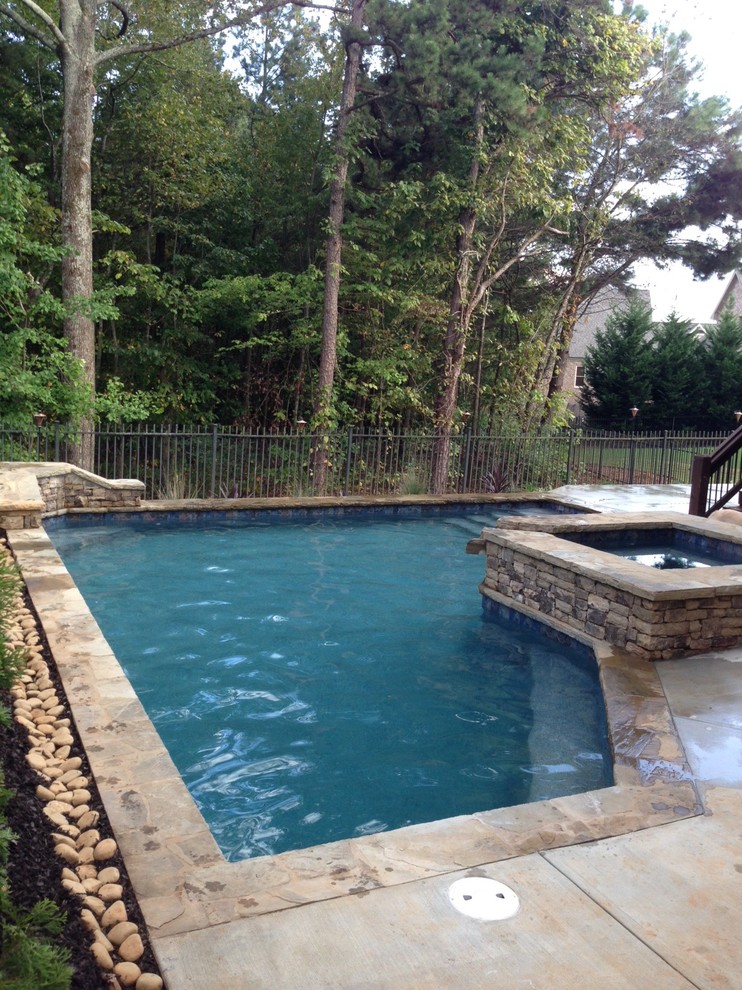 Inspiration for a small arts and crafts backyard custom-shaped pool in Atlanta with a hot tub and decking.