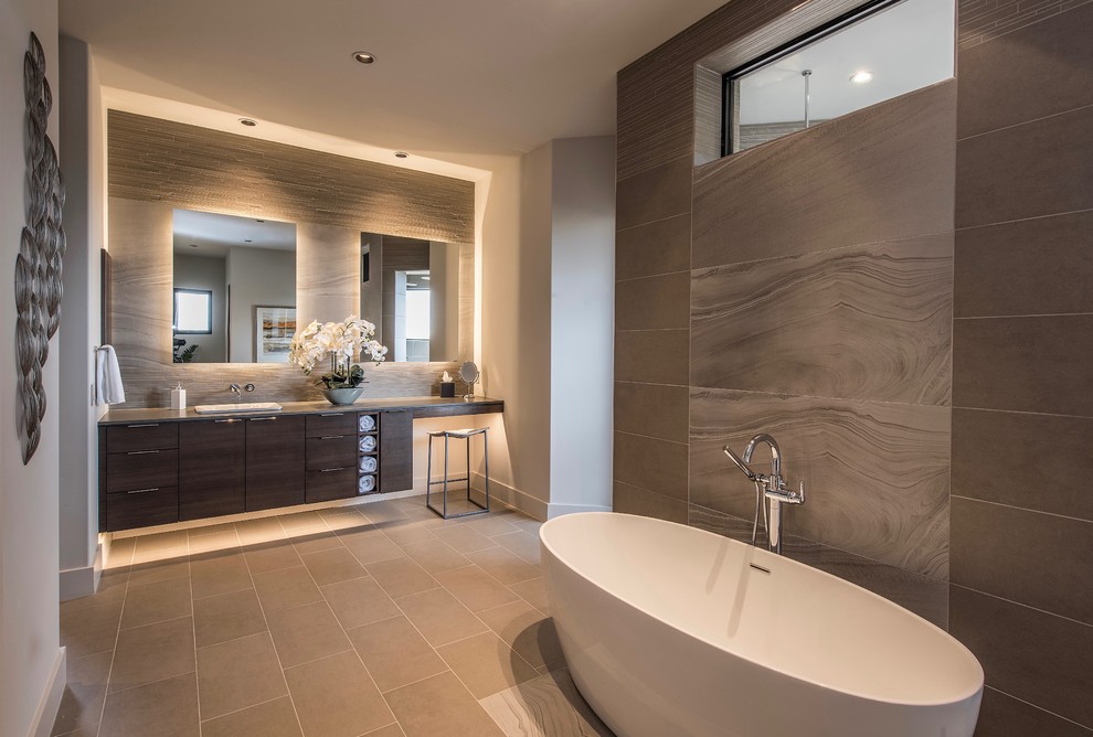 Inspiration for a large contemporary master bathroom in Phoenix with flat-panel cabinets, dark wood cabinets, a freestanding tub, porcelain tile, beige walls, porcelain floors, a drop-in sink, grey floor and grey benchtops.