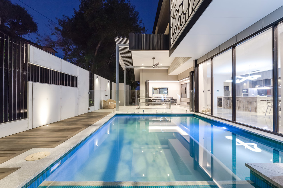 Inspiration for a mid-sized industrial courtyard custom-shaped natural pool in Brisbane with decking.