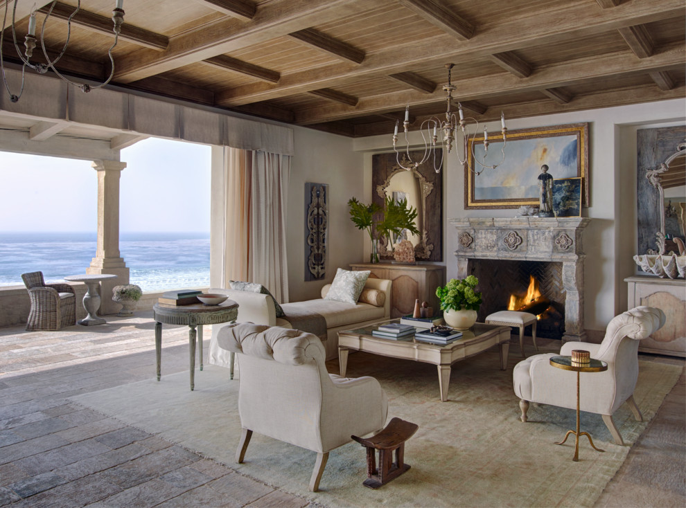 This is an example of a mid-sized mediterranean formal open concept living room in Orange County with white walls, a standard fireplace, light hardwood floors, a stone fireplace surround, no tv and beige floor.