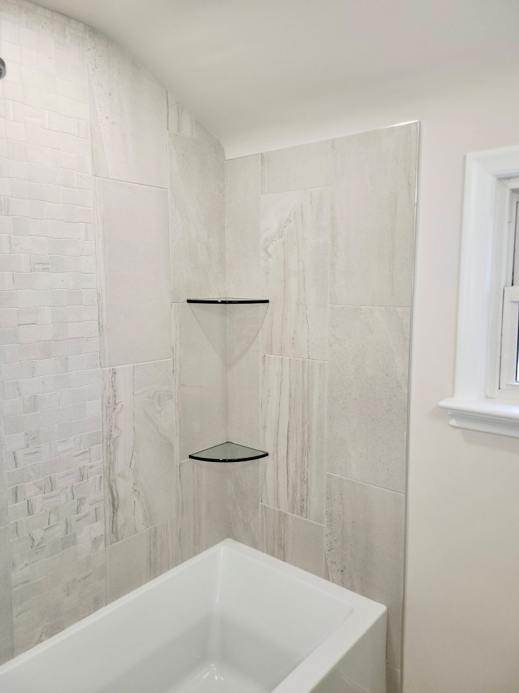 Пример оригинального дизайна: маленькая ванная комната в стиле неоклассика (современная классика) с белыми фасадами, ванной в нише, душем над ванной, унитазом-моноблоком, керамогранитной плиткой, белыми стенами, полом из керамогранита, душевой кабиной, монолитной раковиной, белой столешницей, тумбой под одну раковину и напольной тумбой для на участке и в саду