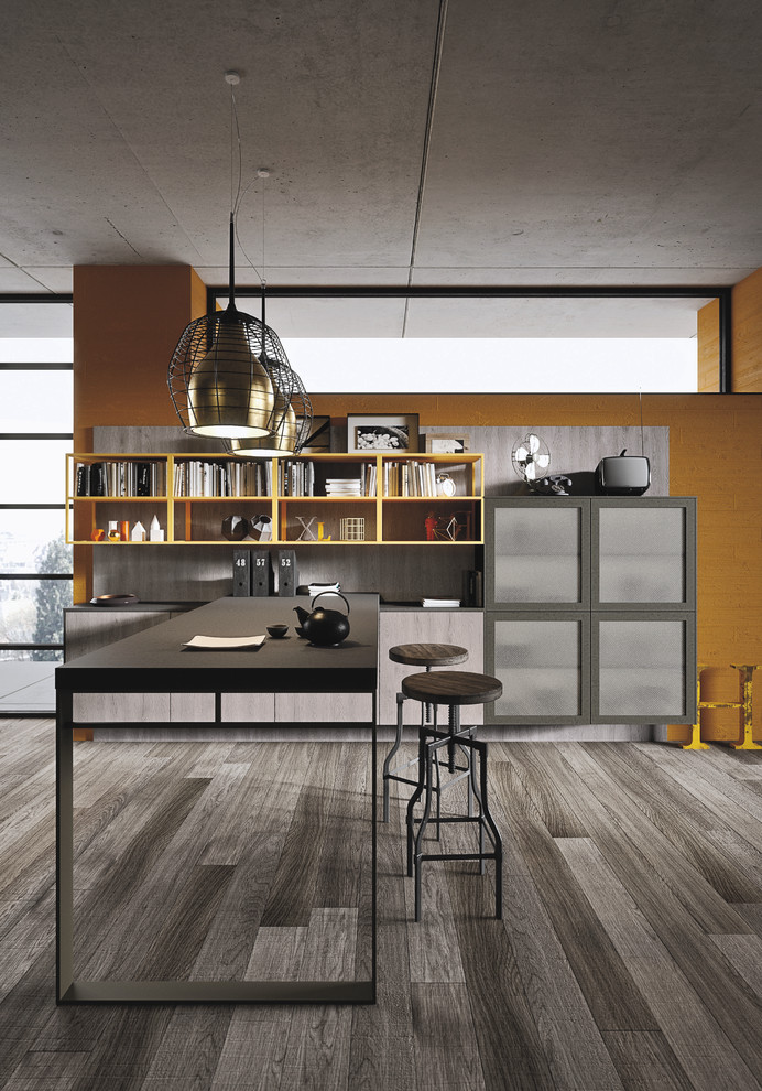 This is an example of a mid-sized industrial l-shaped open plan kitchen in Marseille with an integrated sink, glass-front cabinets, light wood cabinets, concrete benchtops, grey splashback, cement tile splashback, black appliances, painted wood floors and with island.