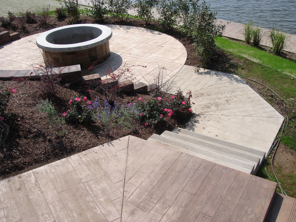 Inspiration for an expansive modern backyard patio in Indianapolis with a fire feature and stamped concrete.